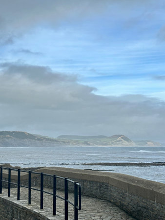 Walking along the seaside promenade in lyme Regis Dorset UKの写真素材