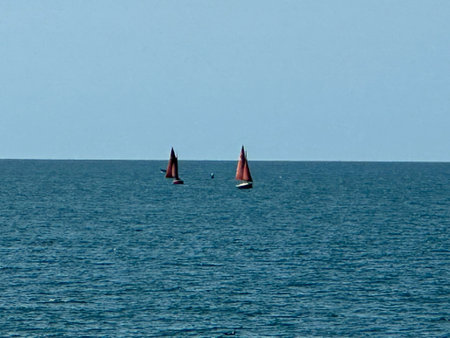 Sailboats in the sea. Two sailboats on the horizon.の写真素材