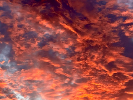 Dramatic sunset sky with red and blue clouds. Nature background