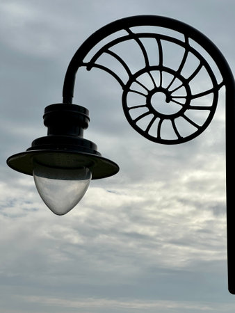 Lantern against a cloudy sky, detail of a modern street lamp.の写真素材