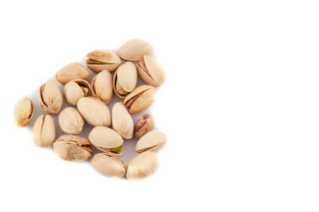 beautiful still life of heart of pistachios in a white backgroundの写真素材