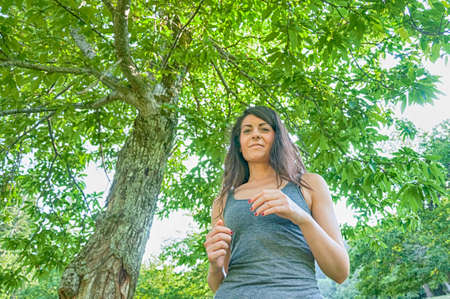 Female athlete runner running on park   jog workout wFemale athlete runner running on park - jog workout well-beingの写真素材
