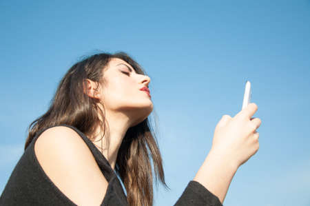 selfie of a beautiful girl in a sunny dayの写真素材