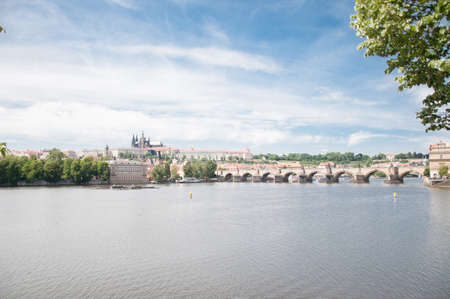 beautiful panorama of a sunny day of moldava river with charles bridge in backgroundの写真素材