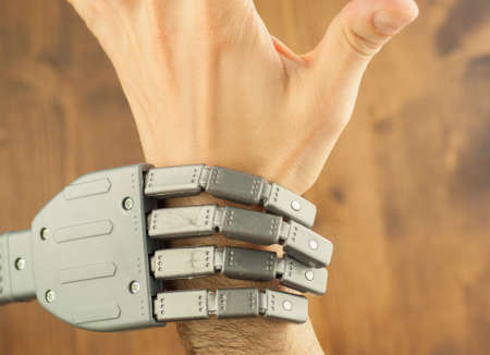 robot and human hand in a battle for work