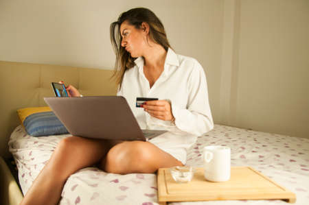 beautiful girl pay on line at homeの写真素材