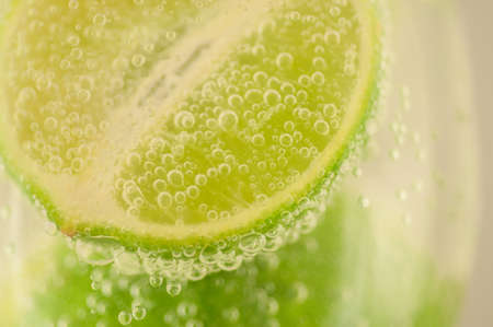 beautiful macro of lime and bubble water for a fresh cocktailの写真素材