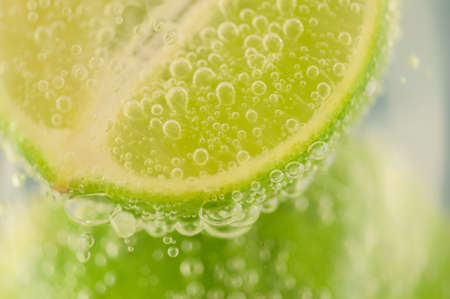 beautiful macro of lime and bubble water for a fresh cocktailの写真素材