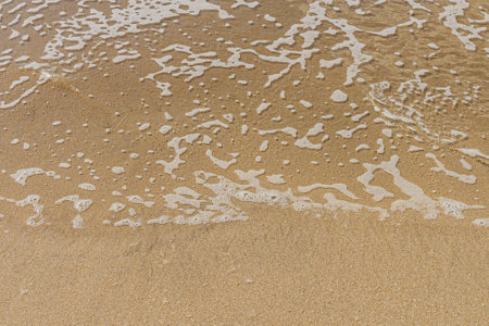 Soft wave of the sea on the sandy beach. Close-up.の写真素材