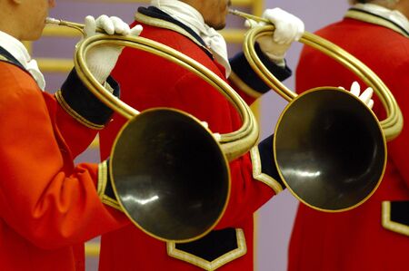 details of musicians group  playing on hunting horn and with traditionnal red dress - fox hunting paradeの写真素材