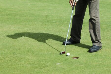Final putt on golf green course
