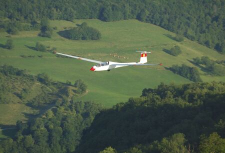 A glider Janus A flying over Alps Mountains at Challes les eaux France