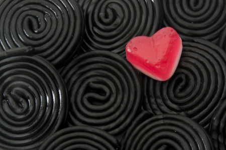 Jelly red  heart over liquorice black spiralsの写真素材