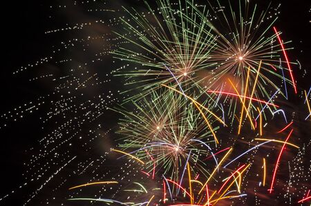 Spectacular fireworks show, color light sparks over black background.の写真素材
