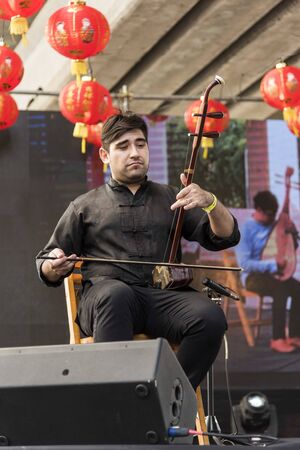 Capital Federal, Buenos Aires / Argentina; Jan 25, 2020: Young musician performing an erhu, a traditional Chinese musical instrument, in the celebrations of the Chinese new yearのeditorial素材