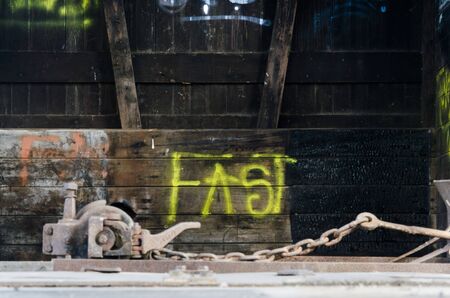 Rauch, Buenos Aires / Argentina; Sept 20, 2014: Fast word written with yellow spray paint inside abandoned train carのeditorial素材