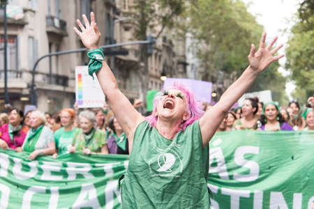 CABA, Buenos Aires / Argentina; March 9, 2020: international women's day. Expressive woman marching in support of the approval of the law of legal, safe and free abortionのeditorial素材