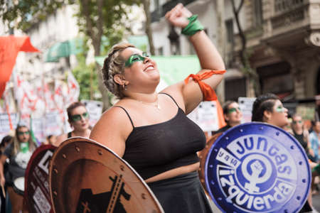 CABA, Buenos Aires / Argentina; March 9, 2020: international women's day. Feminist strike. Young woman defending the law of legal, safe and free abortion, and the Church / State separationのeditorial素材