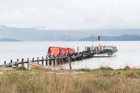 Lake Tota, Boyaca / Colombia: April 7, 2018: Small dock with Colombian flag in the largest lake in...