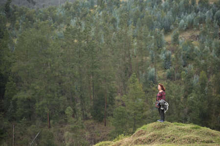 Nemocon, Cundinamarca / Colombia; March 24, 2018: female traveler on top of a hill admiring the...