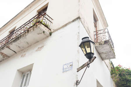 Portugal Street. Colonial style details: balconies, signposting and lantern. Colonia del Sacramento, Uruguayの写真素材