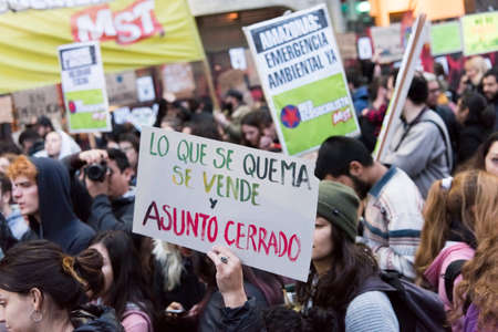 CABA, Buenos Aires / Argentina; Aug 23, 2019: Sign text: What burns is sold and the matter is closed. Protest for the protection of the Amazon and against Brazilian environmental policiesのeditorial素材