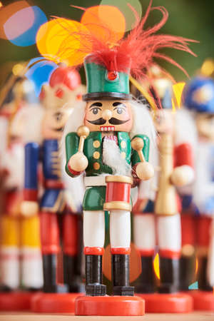 Traditional colorful Christmas nutcrackers with a green background with colored lights out of focus....