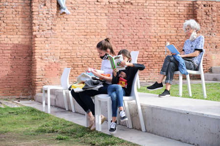 Buenos Aires, Argentina; April 2, 2021: women of different ages at a reading activity keeping distance for the prevention of covid, during the Felba, Publishers and Bookstores Fairのeditorial素材