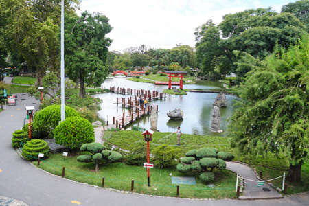 Buenos Aires, Argentina; March 17, 2021: general view of the Japanese garden during the corona virus pandemic. Few visitors, distance markers and signs indicating the direction for the tour.のeditorial素材