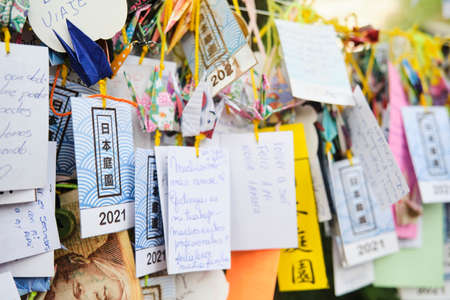 Buenos Aires, Argentina, March 17, 2021: Many strips of paper with wishes written on them, hung in the Japanese garden, following an Asian tradition.のeditorial素材