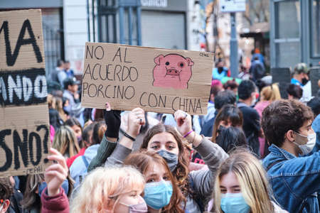 CABA, Buenos Aires, Argentina; Sept 24, 2021: Sign text: No to the pork agreement with China. Young activists protesting during the Global Climate Strike.のeditorial素材