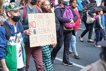 CABA, Buenos Aires, Argentina; Sept 24, 2021: Sign text: The planet cannot sustain this system. Mass protest in the context of the Global Climate Strike.のeditorial素材