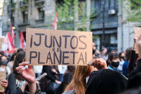 Buenos Aires, Argentina; Sept 24, 2021: Global Climate Strike, image of the protest without recognizable people, hands holding a sign with the text Together for the planet.のeditorial素材