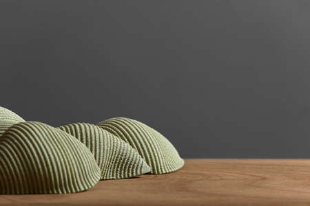 Spinach conchiglioni, dried raw pasta on a wooden surface. Image with copy space, healthy vegetarian food.の写真素材