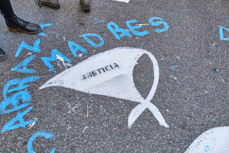Buenos Aires, Argentina; March 24, 2022: National Day of Remembrance for Truth and Justice. White scarf, symbol of the Mothers of Plaza de Mayo, painted on the asphalt, with the word Justice.のeditorial素材