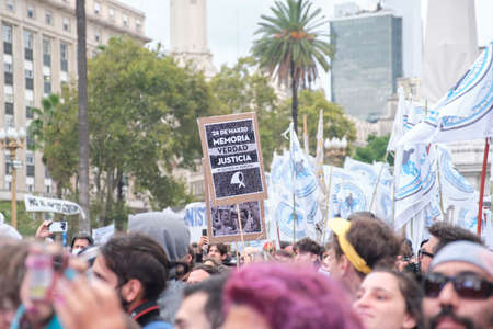 Buenos Aires, Argentina; March 24 2022: National Day of Remembrance for Truth and Justice, crowd in Plaza de Mayo, poster with the text Memory, truth and justice. Neither forgotten nor forgiven.のeditorial素材