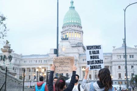 Buenos Aires, Argentina; Nov 1, 2021: World Vegan Day, women holding posters: Veganism is not diet,...