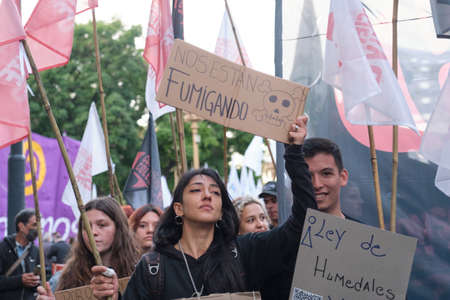 Buenos Aires, Argentina; April 22, 2022: Earth Day demonstration; young woman holding up a sign...
