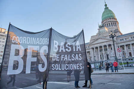 Buenos Aires, Argentina; May 21, 2022: Congress Square, people protesting against the GMOs and pesticides in agriculture hold a banner: No more false solutions.のeditorial素材