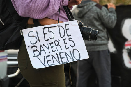 Buenos Aires, Argentina; May 21, 2022: detail of a protest against the use of unhealthy polluting agricultural pesticides. Poster: If it is Bayer, it is poison.のeditorial素材