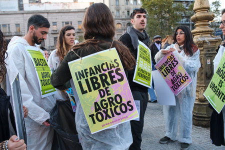 Buenos Aires, Argentina; May 21, 2022: young activists protesting against the use of GMO and toxic pesticides in agriculture. Poster text: Children free of agrotoxics.のeditorial素材