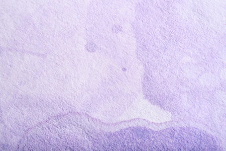Lilac background, textured paper painted with pastel purple paint in a flowing abstract composition with copy space. A ghostly face floating, a funny creative spooky scene.の写真素材