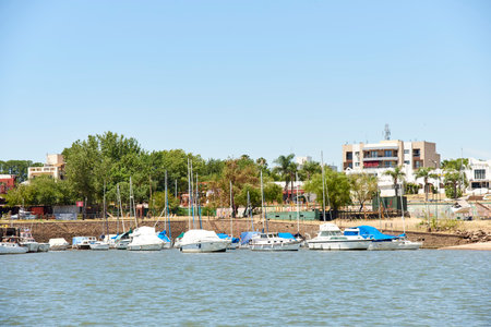 Dec 30, 2021, Colon, Entre Rios, Argentina: port of the city with docked ships as seen from a boat on the Uruguay river.のeditorial素材