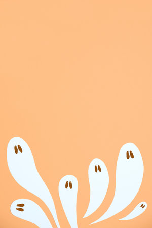Halloween design, group of cute white ghosts flying on pastel orange color background, trendy composition with copy space.の写真素材