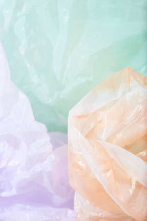 Purple, orange and green background, single use plastic bags. Concepts: sustainability, recycling, pollution.の写真素材