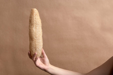 Young female hand holding a loofah, biodegradable ecological vegetable sponge. Concepts: sustainable lifestyle, choice of environmentally friendly products, zero waste campaigns.の写真素材