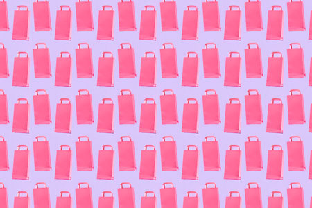 Shopping concept, pastel color pattern, pink trendy paper bags on a lilac background.