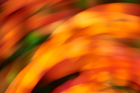 Abstract blurred background, dynamic colorful lights in motion, flowing design in warm vibrant colors.の写真素材