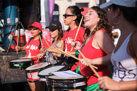 Buenos Aires, Argentina; March 8, 2023: international feminist strike; group of young women playing percussion instruments and chanting slogans, demanding rights.のeditorial素材