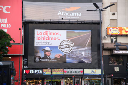 Buenos Aires, Argentina; March 3, 2023: screen with political advertising of the national presidency in downtown CABA. Texts: We said it, we did it. Federal commitment fulfilled.のeditorial素材